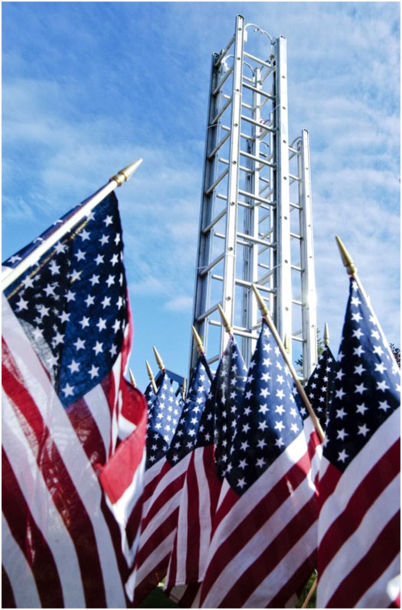 Anchorage -- Fire ladders, constructed into the shapes of the fallen World Trade Center Towers, rise high over the Alaska Fallen Firefighter Memorial located at 5th Avenue and A Street.  In the foreground, 343 U.S. flags honor the firefighters who gave their lives during the September 11th, 2001, attacks in New York City.   (U.S. Air Force photo/Percy Jones)