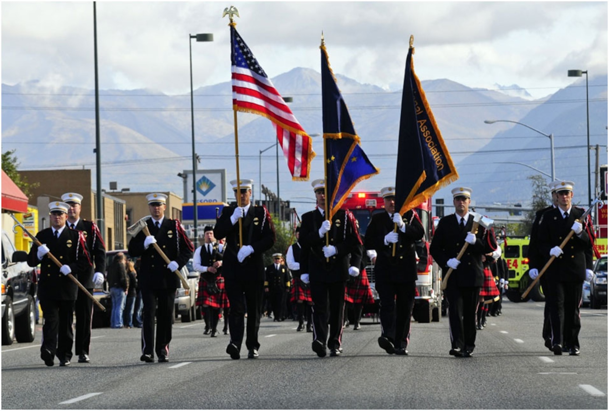 Anchorage -- Members of the Anchorage Fire Department Honor Guard lead a procession of firefighters and engines down 5th Avenue as they head to the Alaska Fallen Firefighter Memorial. (U.S. Air Force photo/Percy Jones)