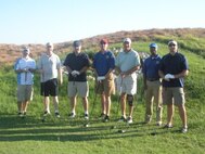 Members of the 12th Flying Training Wing pose for a photo before teeing off on Patriot Golf Day, Sept. 5, 2011.  The group participated in Patriot Golf Day in remembrance of Maj. Jeff Ausborn, 99th Flying Training Squadron instructor pilot.  Maj. Ausborn was killed in Kabul, Afghanistan in April when a shooter opened fire during a meeting.  Patriot Golf Day is an effort to raise money through greens fees at participating courses on Labor Day each year.  The money raised supports scholarships for children of military members killed or wounded in the service of our
country. (U.S. Air Force Photo/Bekah Clark)
