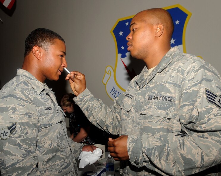 Airman 1st Class Kristin Thomas, 2nd Logistics Readiness Squadron, receives the flu mist from Staff Sgt. Brandon Scott, 2nd Aerospace Medicine Squadron, in Hoban Hall on Barksdale Air Force Base, La., Sept. 19. 2 AMDS delivered more than 11,000 flu vaccinations throughout the 2010-2011 season.(U.S. Air Force photo/Senior Ariman Kristin High)(RELEASED)