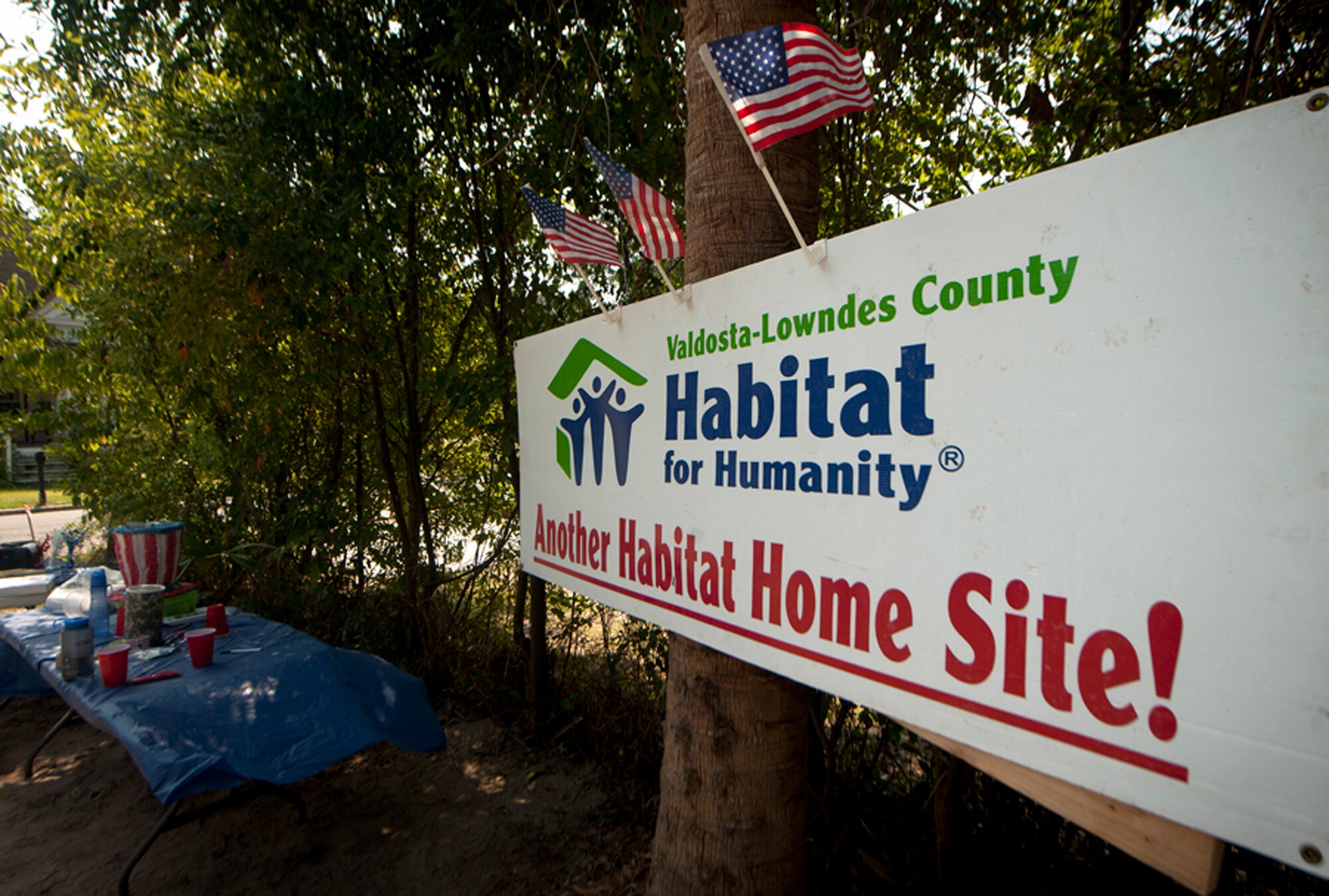 A Habitat for Humanity sign displays the saying “Another Habitat Home Site!” during a ribbon-cutting ceremony in Valdosta, Ga., Sept. 17, 2011. Habitat for Humanity is a non-profit organization that seeks to eliminate poverty housing and homelessness. Within a week’s span, members of the group, Airmen from Moody Air Force Base, Ga., and volunteers from the Valdosta community helped build a brand new home for a local family. (U.S. Air Force photo by Airmen 1st Class Joshua Green/Released)         
