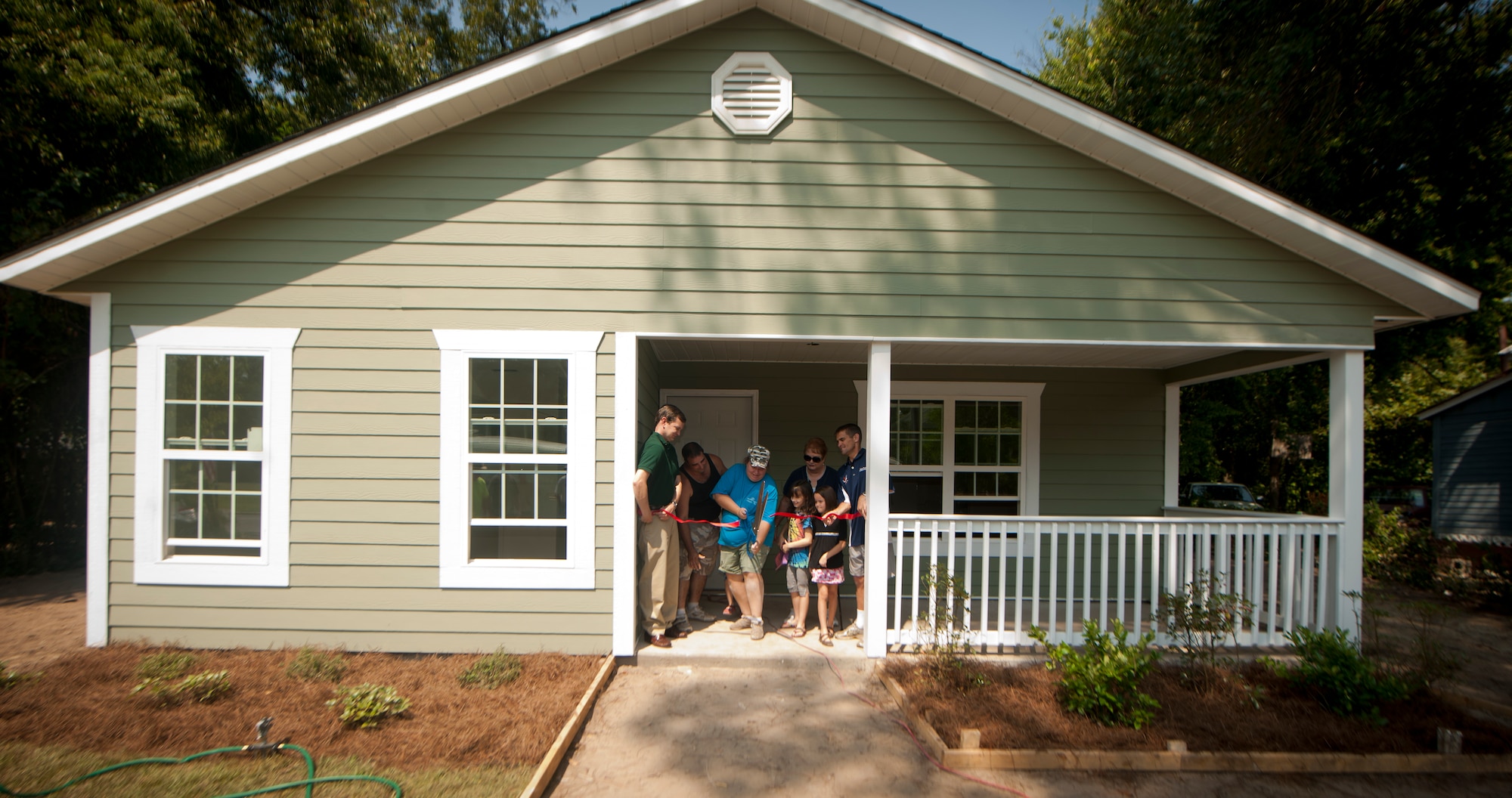 Miranda Mabry cuts the ribbon on her brand new home during a ceremony in part of the 2nd Annual Valdosta-Lowndes County Habitat for Humanity Freedom Build in Valdosta, Ga., Sept. 17, 2011. Miranda and Tim Mabry, their three children and Tim’s mother, Carol Cooper, will all occupy the newly built house. (U.S. Air Force photo by Airmen 1st Class Joshua Green/Released)    
