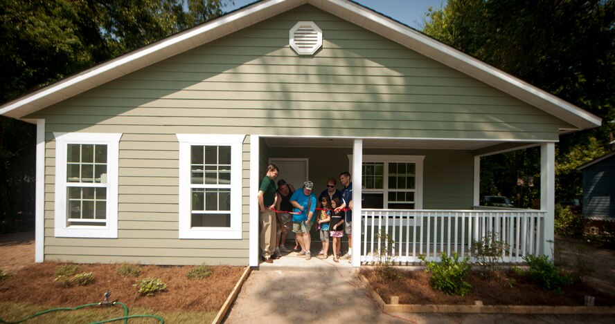 Miranda Mabry cuts the ribbon on her brand new home during a ceremony in part of the 2nd Annual Valdosta-Lowndes County Habitat for Humanity Freedom Build in Valdosta, Ga., Sept. 17, 2011. Miranda and Tim Mabry, their three children and Tim’s mother, Carol Cooper, will all occupy the newly built house. (U.S. Air Force photo by Airmen 1st Class Joshua Green/Released)    

