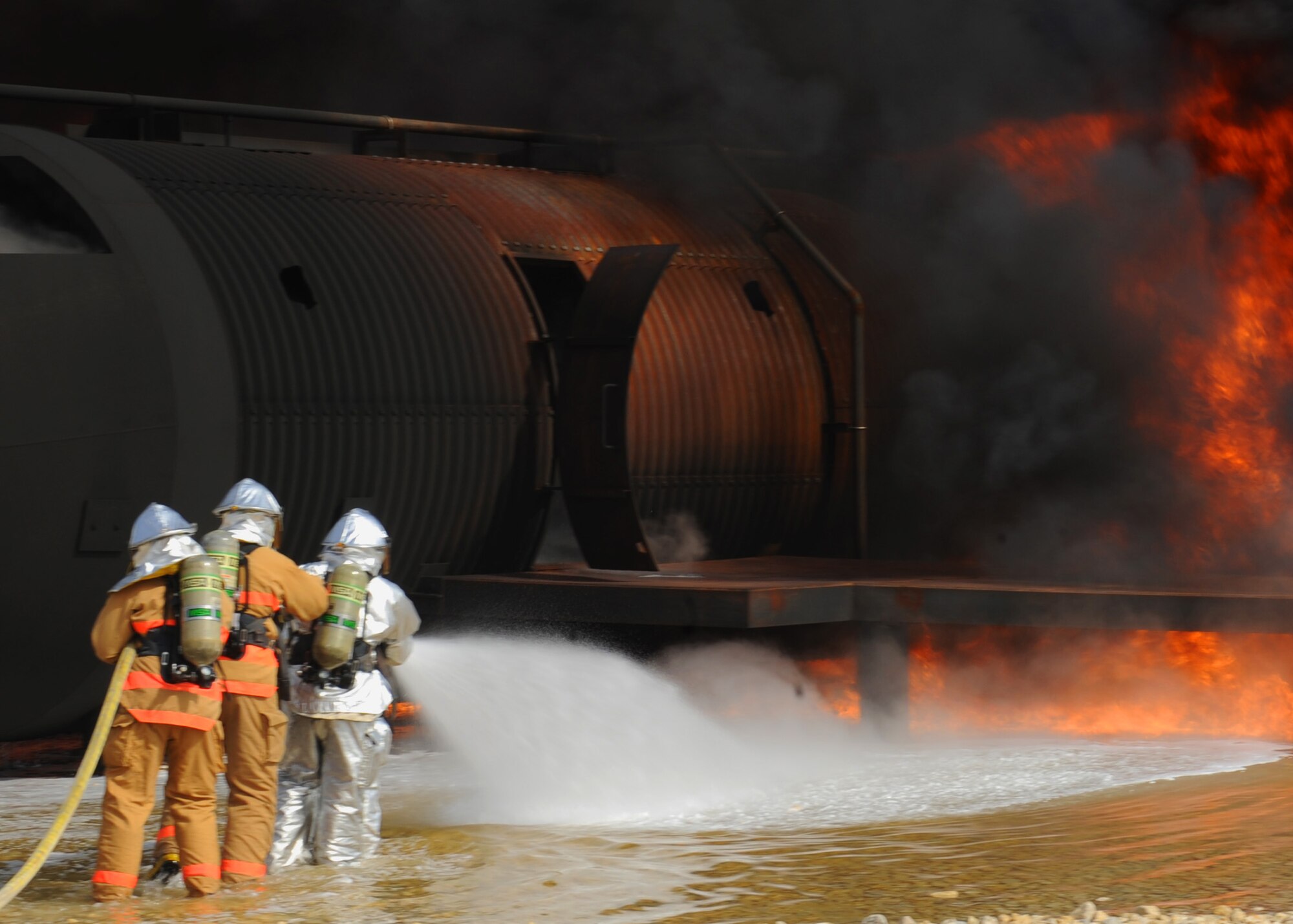 Dyess , Abilene Regional airport (ABI) and Abilene Fire Department firefighters team up to extinguish an aircraft fire during a joint training exercise at Dyess Air Force Base, Texas,  Sept. 16, 2011. Firefighters from ABI are required by the Federal Aviation Association (FAA) to be proficient in extinguishing aircraft fires. By inviting them onto the base, Dyess firefighters facilitate a means to achieve their annual training and foster a working relationship. (U.S. Air Force Photo by Airman 1st Class Cierra Bullock/Released) 