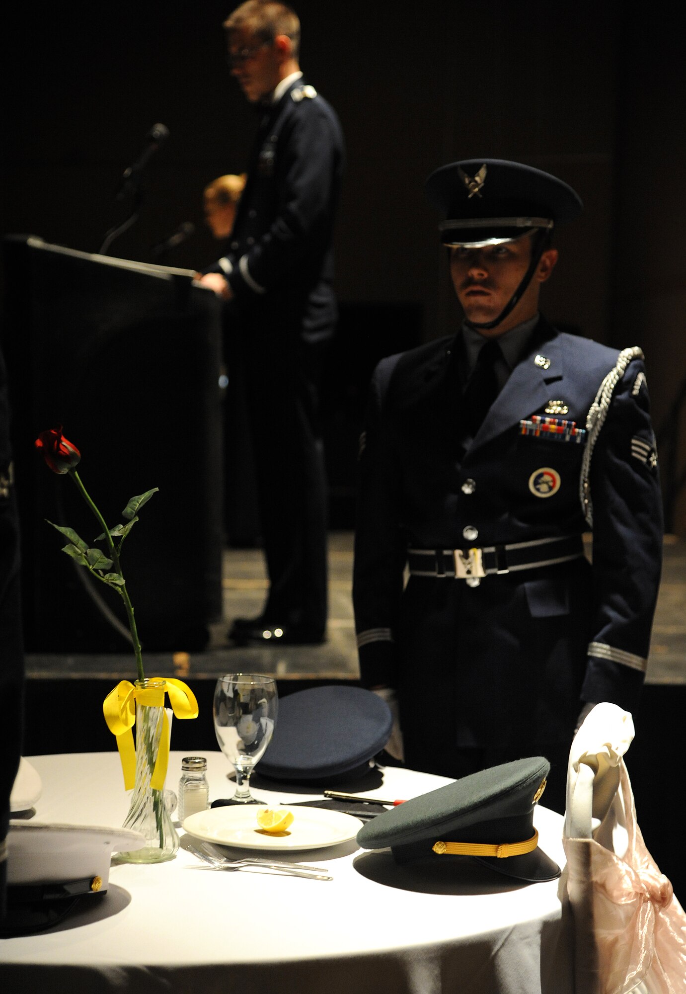 SAN ANGELO, Texas -- Senior Airman Christopher Thompson, 17th Communications Squadron, stands behind the POW/MIA table during the Air Force Ball Sept. 16 at the McNease Convention Center. The table was set as a symbol of the fellow service members who are still missing. (U.S. Air Force photo/Airman 1st Class Michael Smith)