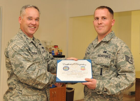 MOUNTAIN HOME AIR FORCE BASE, Idaho – Staff Sgt. Brian Vetter, 366th Maintenance Operations Squadron standardization lead crew 3 member, receives an award from Col. James McClellan, 366th Maintenance Group commander, here Sept. 7. Vetter received  Air Combat Command’s Outstanding Armament Systems Technician Award for identifying a munitions fuse flaw.(U.S. Air Force photo by Airman 1st Class Heather Hayward)