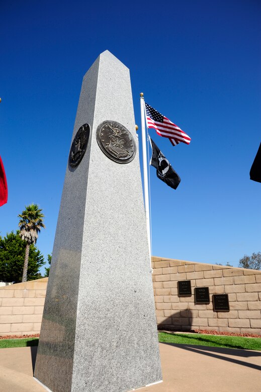 VANDENBERG AIR FORCE BASE, Calif. – An obelisk stands in front of the American flag and the prisoner of war/missing in action flag at the POW/MIA memorial during a ceremony here Friday, Sept. 16, 2011. The obelisk has a plaque of each five branches of the U.S. military implanted on its four sides in honor of the fallen members of each service. (U.S. Air Force photo/Senior Airman Lael Huss)