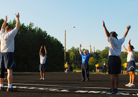 Members from Dobbins perform warm-up stretches in preparation for fit camp held at the running track here Sept. 14. The boot-camp type training is conducted for Dobbins servicemembers during the week rotating between aerobic and anaerobic exercises. (U.S. Air Force photo/Airman 1st Class Chelsea Smith)