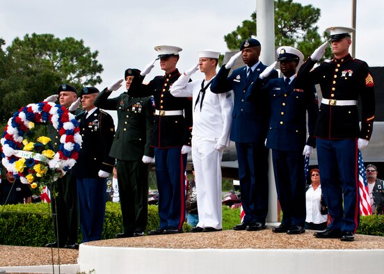 Joint-service honor guard members representing all five military services salute during the 21-gun salute at the POW/MIA ceremony Sept. 16 at the Air Force Armament Museum. The ceremony paid tribute to those military members who have yet to return home from defending America. The event was hosted by the 46th Test Wing and featured guest speakers, honor guard procedures and a flyover by the 53rd Wing. (U.S. Air Force photo/Samuel King Jr.)