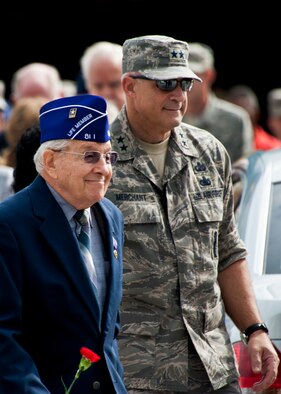 Maj. Gen. Kenneth Merchant, the Air Armament Center commander, escorts a Military Order of the Purple Heart member to his seat prior to the outdoor portion of the POW/MIA ceremony Sept. 16 at the Air Force Armament Museum. The ceremony paid tribute to those military members who have yet to return home from defending America. The event was hosted by the 46th Test Wing and featured guest speakers, honor guard procedures and a flyover by the 53rd Wing. (U.S. Air Force photo/Samuel King Jr.)