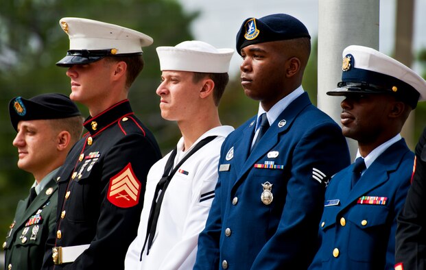 Joint-service honor guard members representing all five military services stand in front of the audience before the outdoor portion of the POW/MIA ceremony Sept. 16 at the Air Force Armament Museum. The ceremony paid tribute to those military members who have yet to return home from defending America. The event was hosted by the 46th Test Wing and featured guest speakers, honor guard procedures and a flyover by the 53rd Wing. (U.S. Air Force photo/Samuel King Jr.)