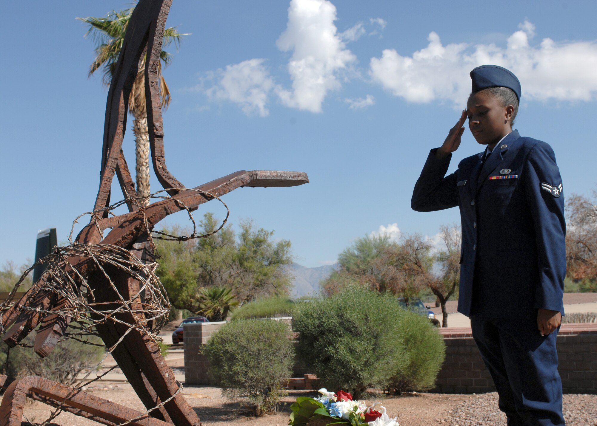 DAVIS-MONTHAN AIR FORCE BASE, Ariz. – Airman 1st Class Jelisa Monk, 355th Fighter Wing knowledge operations manager, salutes the wreath placed in front of the Prisoner of War Memorial in Heritage Park here Sept. 16. The wreath was placed in remembrance of POW’s and troops missing in action during the POW/MIA ceremony. (U.S. Air Force photo/Airman 1st Class Timothy D. Moore)