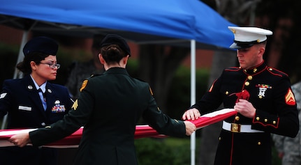 Members of Joint Base Charleston fold the flag during the Prisoner of War/Missing in Action Retreat Ceremony on September 16, 2011, Joint Base Charleston, S.C.  Team Charleston honored POW/MIA rememberance d Base ay with a 24-hour run that ended at the retreat ceremony followed by a wreath laying and a fly-over.  Former POW's were in attendance.  (U.S. Air Force photo/ Staff Sgt. Nicole Mickle) (RELEASED)  