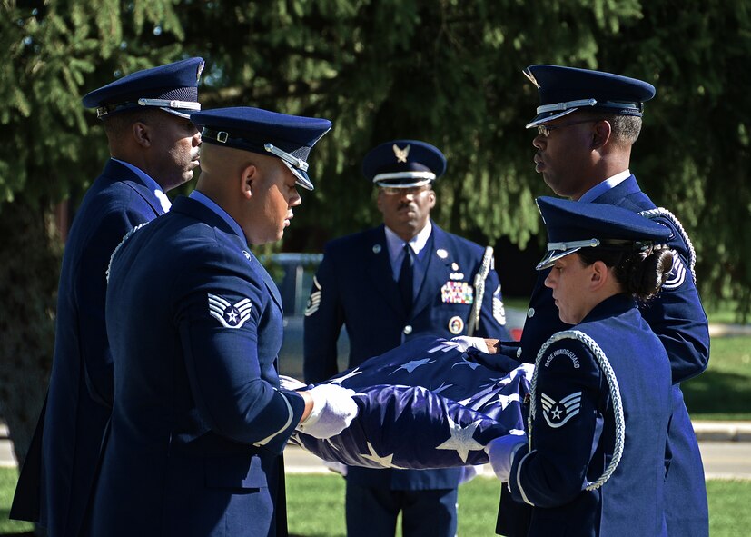 WRIGHT-PATTERSON AIR FORCE BASE, Ohio - Master Sgt. Mark Lyle, superintendant Wright-Patterson Air Force Base Honor Guard and 445th Airlift Wing member, watches over his honor guard team as they finish folding the flag during a formal retreat at the 88th Air Base Wing Headquarters Sept. 15. Wright-Patt honored National POW/MIA Recognition Day with a wreath laying ceremony at the Arnold House prior to the group formation. (U.S. Air Force photo/Senior Airman Mikhail Berlin)