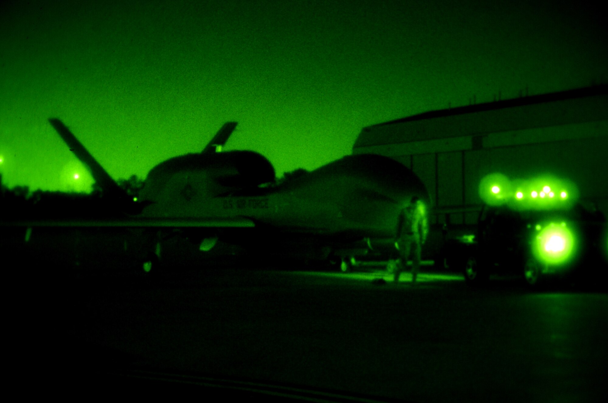 Airmen from the 69th Maintenance Squadron move a RQ-4 Global Hawk on the flight line on Grand Forks Air Force Base Sept. 19. The Global Hawk covers intelligence collection capability to support forces in worldwide peace, crisis and wartime operations. The capabilities of the aircraft allow more precise targeting of weapons and better protection of forces through superior surveillance capabilities. (U.S. Air Force photo by Senior Airman Amanda N. Stencil)