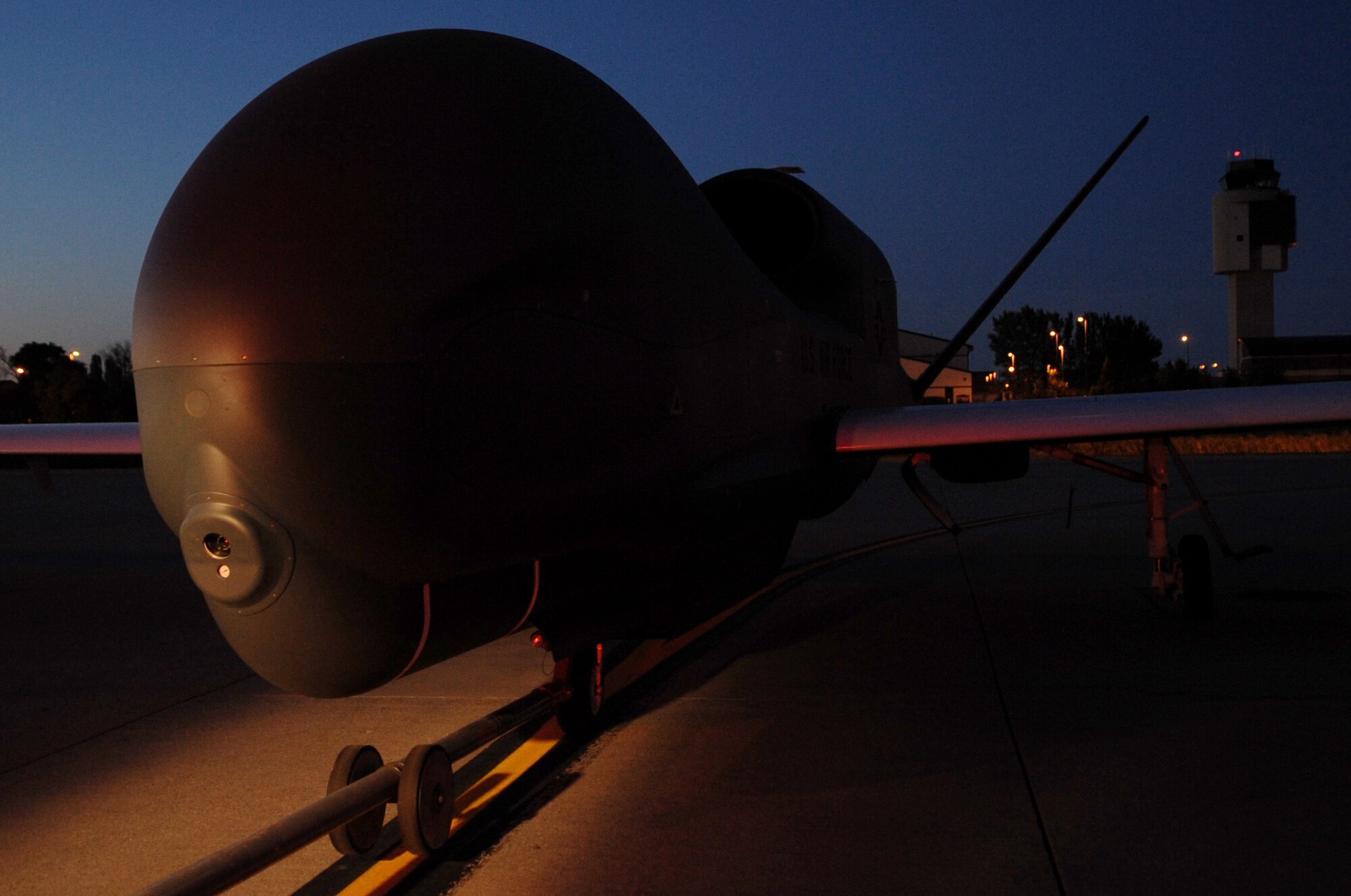 A RQ-4 Global Hawk is moved on the flight line on Grand Forks Air Force Base Sept. 19. The Global Hawk covers intelligence collection capability to support forces in worldwide peace, crisis and wartime operations. The capabilities of the aircraft allow more precise targeting of weapons and better protection of forces through superior surveillance capabilities. (U.S. Air Force photo by Senior Airman Amanda N. Stencil)