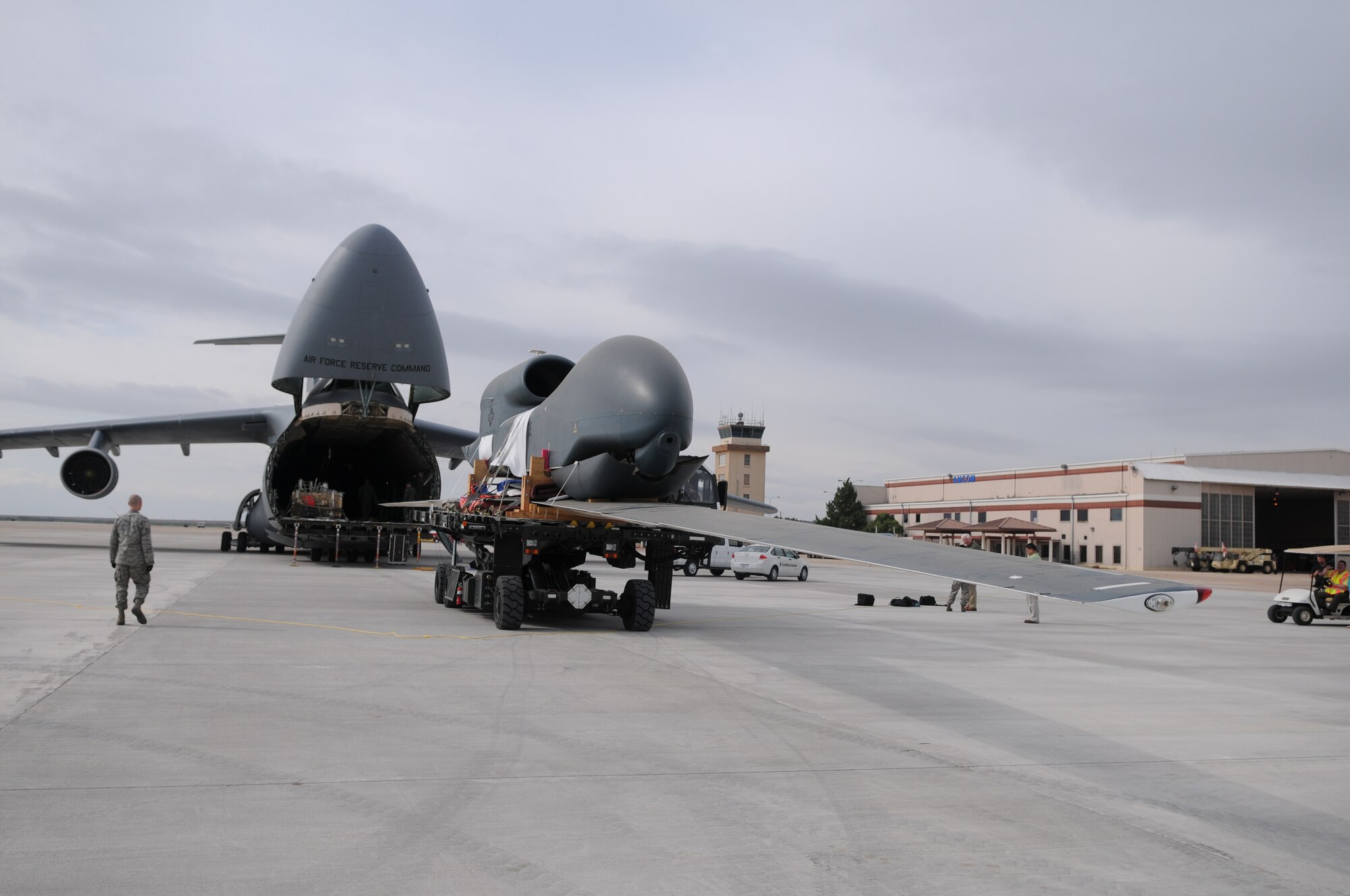 SAN ANGELO, Texas – A C-5 Galaxy, from Westover Air Reserve Base, Mass., delivers an RQ-4 Global Hawk at San Angelo Regional Airport/Mathis Field, Sept 14. The aircraft transported two of the decommissioned drones from Beale Air Force Base, Calif. These drones are the first of their kind to be used as static displays, one of which will be at Goodfellow Air Force Base, Texas. (U.S. Air Force Photo /Senior Airman Heather L Rodgers)

