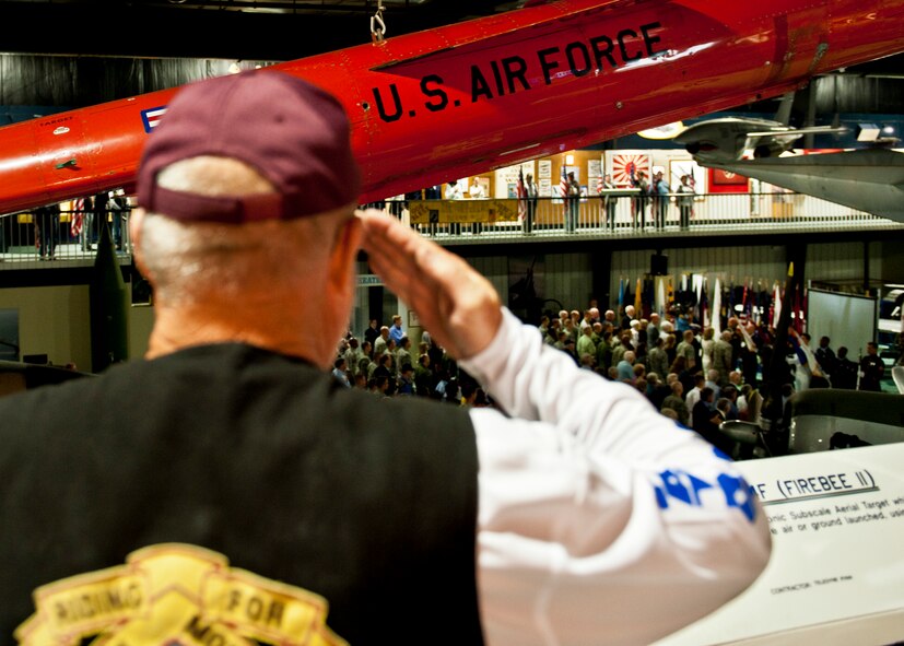 A member of the Patriot Guard salutes as the flag is presented during the National Anthem at the POW/MIA ceremony Sept. 16 at the Air Force Armament Museum. The ceremony paid tribute to those military members who have yet to return home from defending America. The event was hosted by the 46th Test Wing and featured guest speakers, honor guard procedures and a flyover by the 53rd Wing. (U.S. Air Force photo/Samuel King Jr.)