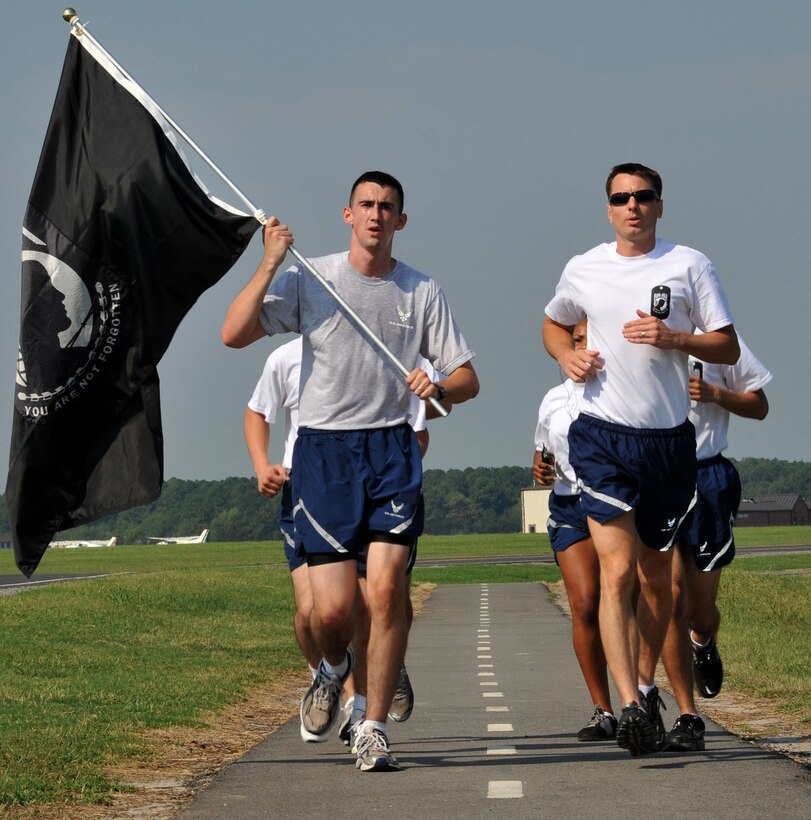 Airmen run in formation during the POW/MIA 24-hour run around Langley Air Force Base, Va., Sept. 15, 2011. The run ended at the Prisoner Of War/Missing In Action Memorial on base for the beginning of the POW/MIA ceremony. (U.S. Air Force photo by Airman 1st Camilla Griffin/Released)