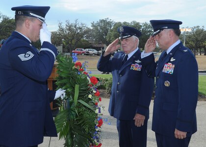 Retired Lt. Col. Ramon Horinek, a former prisoner of war, and Col. Richard Murphy, 12th Flying Training Wing commander at Randolph Air Force Base, salute before the wreath during the base's POW/MIA Recognition Day ceremony Sept. 16, in front of the base's Missing Man Monument. The United States' National POW/MIA Recognition Day is observed across the nation on the third Friday of September each year. On this day, Americans across the United States pause to remember the sacrifices and service of those who were prisoners of war, as well as those who are missing in action and their families. (U.S. Air Force photo/Rich McFadden)