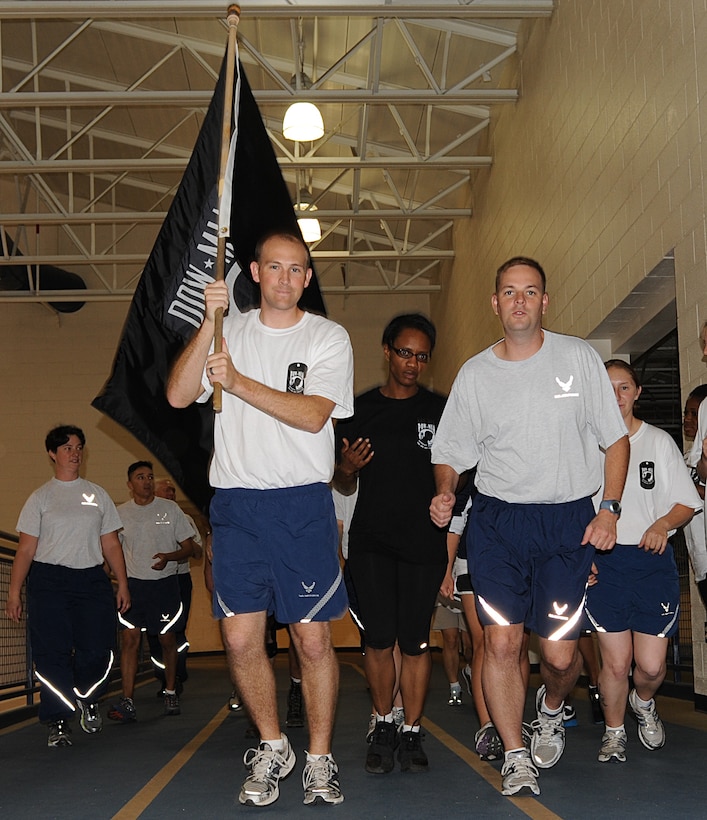 Volunteers run during the POW/MIA 24 Hour Run/Walk Vigil at Langley Air Force Base, Va., Sept. 15, 2011. Volunteers kept the POW/MIA flag moving for 24 hours for the annual run. More than 350 runners participated in the second annual event. (U.S. Air Force photo by Airman 1st Class Teresa Cleveland/Released)