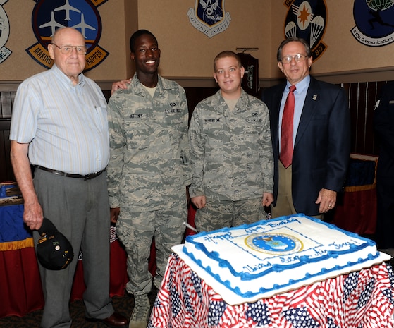 (Left to right) Robert Dunbar, Airman 1st Class Michael Jefferies, Airman 1st Class Don Howerton and Charles Jackson prepare to cut a birthday cake in honor of the Air Force's 64th birthday at the Charleston Club Sept. 16. Jefferies and Howerton were chosen to cut the cake because they are the youngest Airmen assigned to the 437th Airlift Wing. Howerton is assigned to the 437th Maintenance Squadron and Jefferies is assigned to the 437th Operation Support Squadron. Jackson and Dunbar were both prisoners of war and were also attending the POW/MIA luncheon held at the Charleston Club. (U.S. Air Force photo/Airman 1st Class Ashlee Galloway)