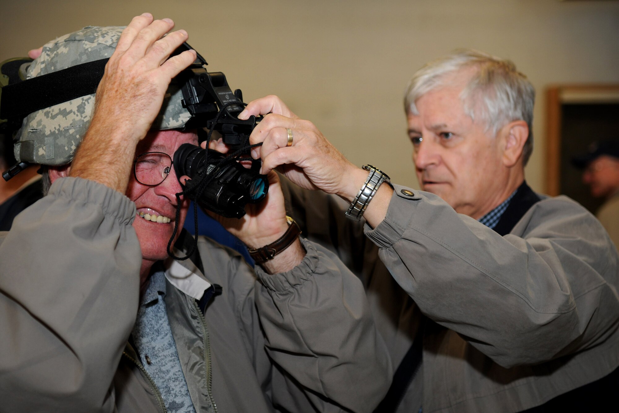 GRISSOM AIR RESERVE BASE, Ind. --  Ed Wright, a member of the Britton Falls Veterans group, tries on a night vision helmet at the U.S. Army reserve's 316th Tactical Psychological Operations Company here Sept. 7. The group toured the base to learn about the history and involvement that Grissom plays not only for the Air Force, but in the surrounding community. Assisting Ed is Jerry Casey, Britton Falls Veterans group member. (U.S. Air Force photo/Senior Airman Jami K. Lancette)