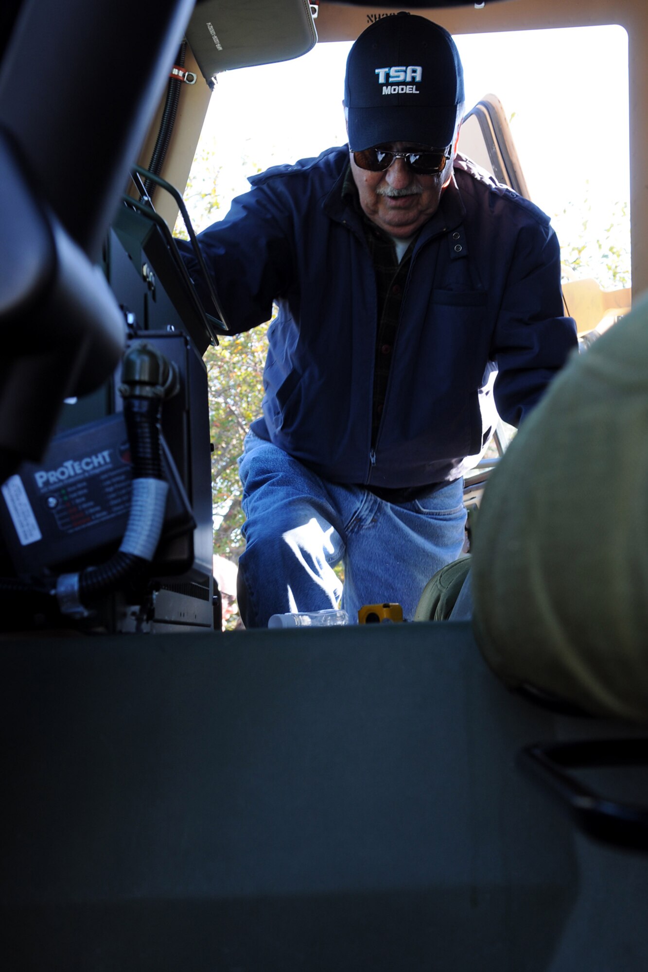 GRISSOM AIR RESERVE BASE, Ind. -- Ken Wilson, Britton Falls Veterans group, climbs into a Humvee during a tour at the U.S. Army reserve's 316th Tactical Psychological Operations Company here at Grissom Air Reserve Base Sept. 7. The group toured Grissom to gain perspective on the operations of the base and the role it has not only in the military, but in the surrounding community. (U.S. Air Force photo/Senior Airman Jami K. Lancette)