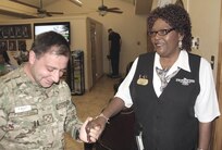 Georgia Army Capt. Aliko Odilavadze and Linda Blount reunite for the first time after Odilavadze saved her life while she was working as a cashier at the Gateway Lodge Sundry Store. (U.S. Air Force photo/Spencer Berry)