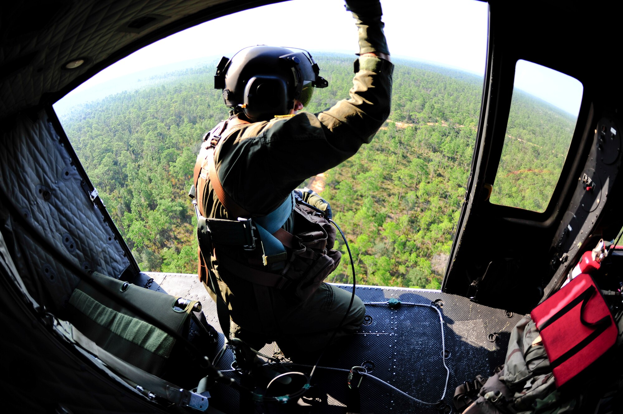 Tech. Sgt. James Kempfer, 40th Flight Test Squadron flight engineer, scans the left side of the UH-1 Huey during a training mission over ranges at Eglin Air Force Base, Fla. Sept. 15.  The mission included rope ladder and cargo sling exercises.  (U.S. Air Force photo/Staff Sgt. Joely Santiago)