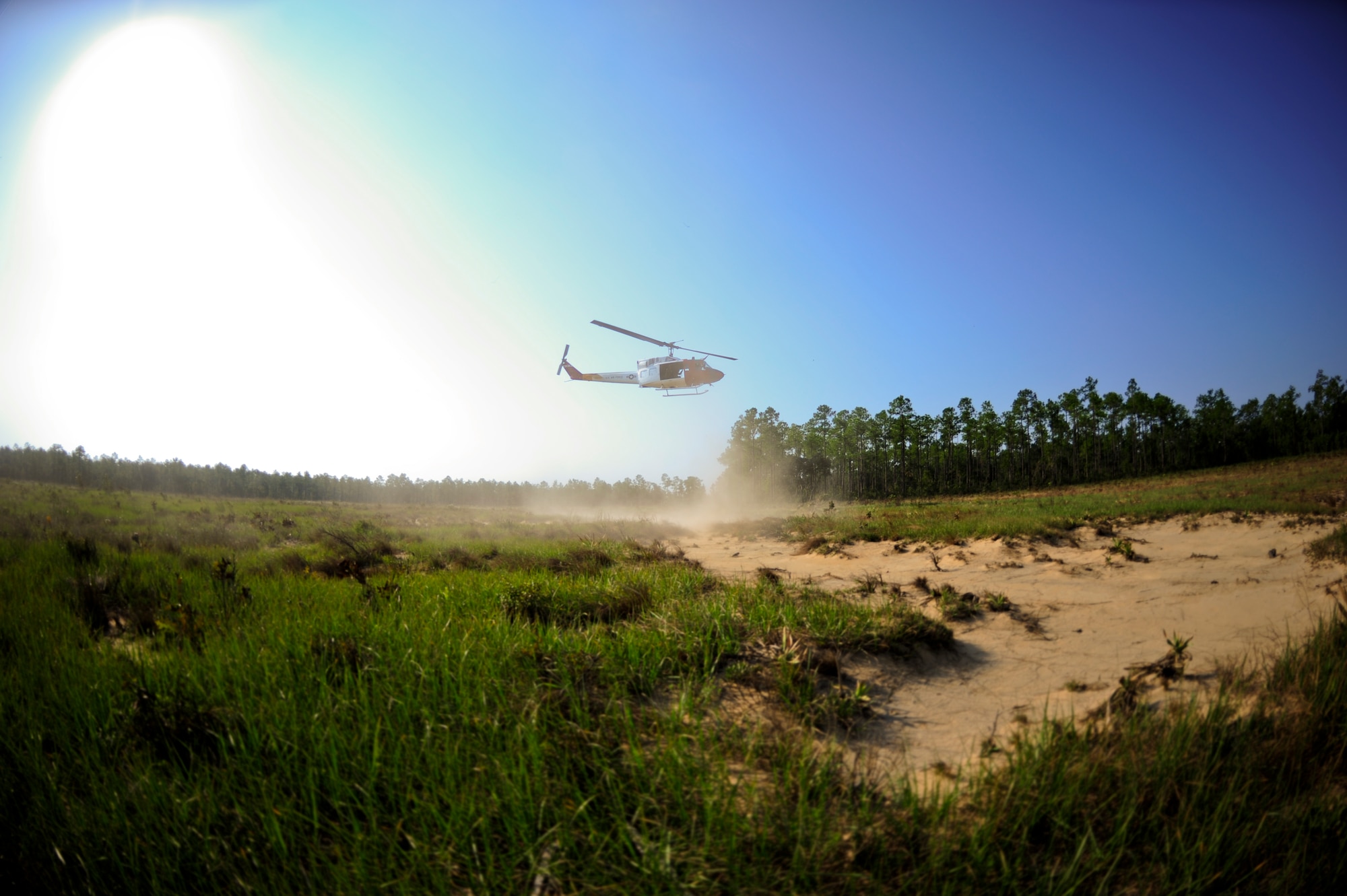 A UH-1 Huey from the 40th Flight Test Squadron takes off from a range on Eglin Air Force Base, Fla. Sept. 15.  During the training mission, flight engineers practiced using the rope ladder and cargo sling. (U.S. Air Force photo/Staff Sgt. Joely Santiago).