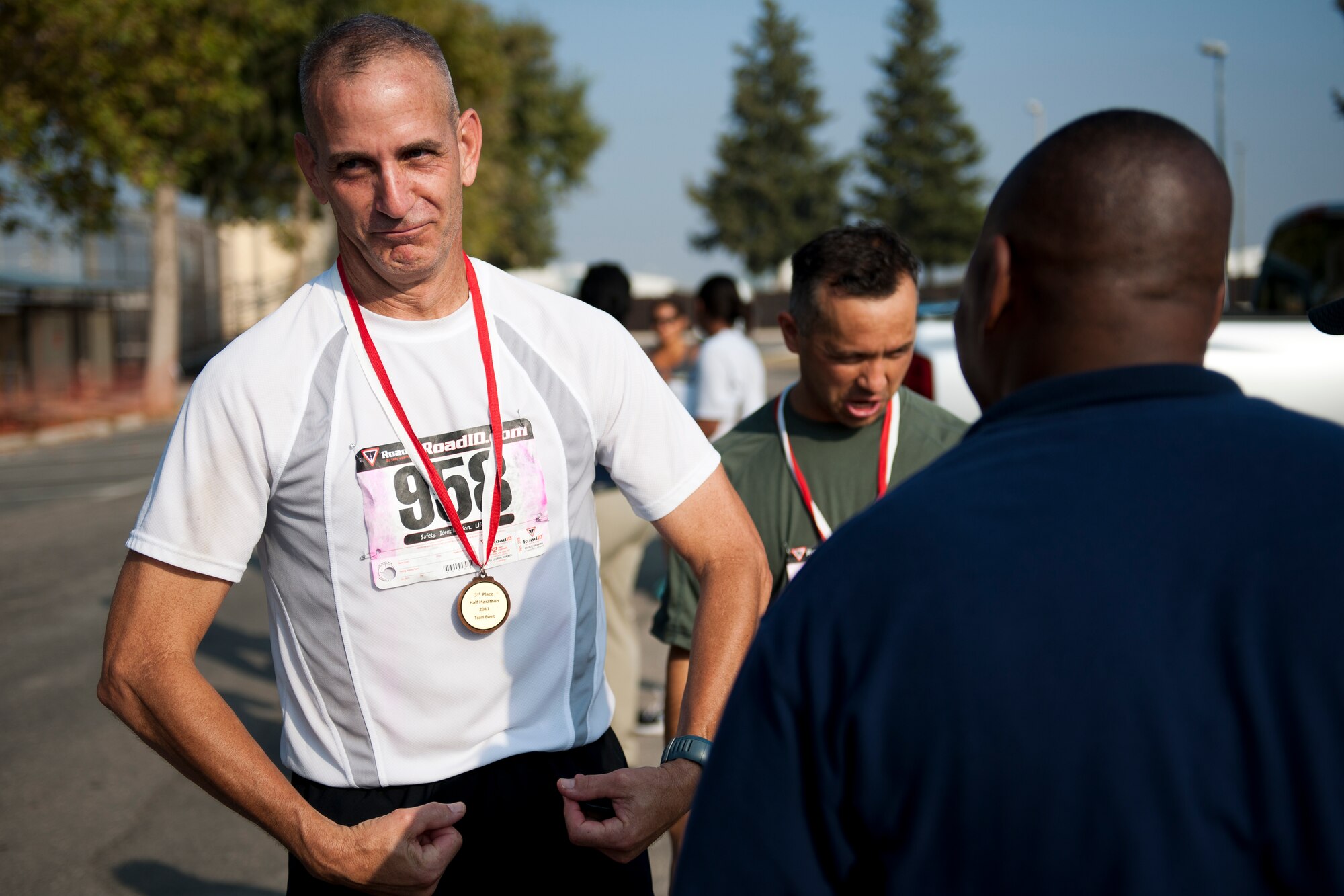 Scott Rummage flexes after the 39th Air Base Wing relay team is awarded 3rd place during the half marathon Sept. 17, 2011, at Incirlik Air Base, Turkey. More than 80 runners participated in the 13.1 mile race that coincided with the annual Air Force Marathon. The 39th ABW team finished the run in 1:43:11. (U.S. Air Force photo by Tech. Sgt. Michael B. Keller/Released)