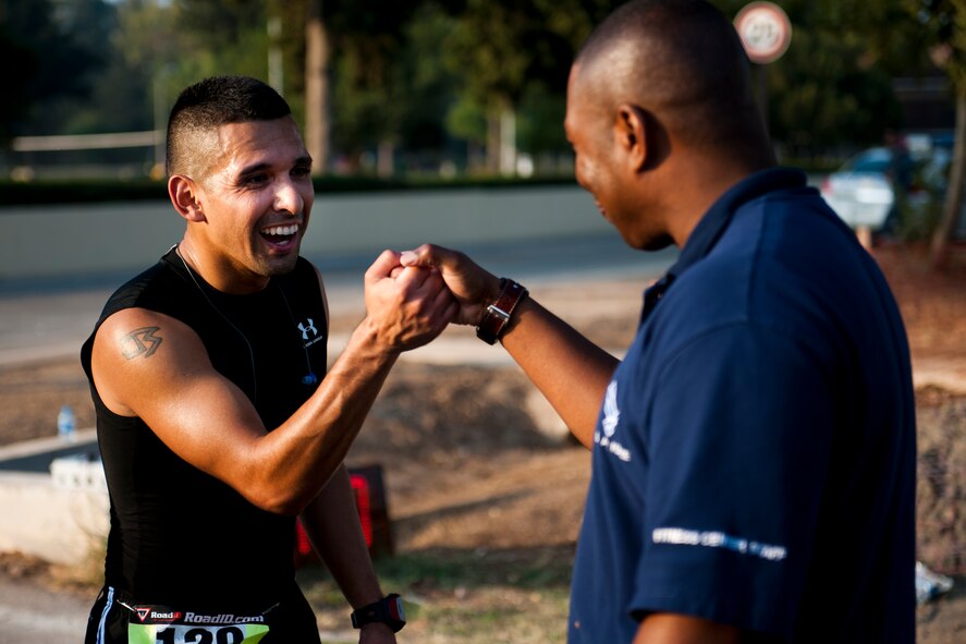 Jaime Sauceda is congratulated by Roy Robinson after finishing the half marathon Sept. 17, 2011, at Incirlik Air Base, Turkey. More than 80 runners participated in the 13.1 mile race that coincided with the annual Air Force Marathon. Sauceda took first place finishing the run in 1:30:40. Sauceda and Robinson are both from the 39th Force Support Squadron. (U.S. Air Force photo by Tech. Sgt. Michael B. Keller/Released)