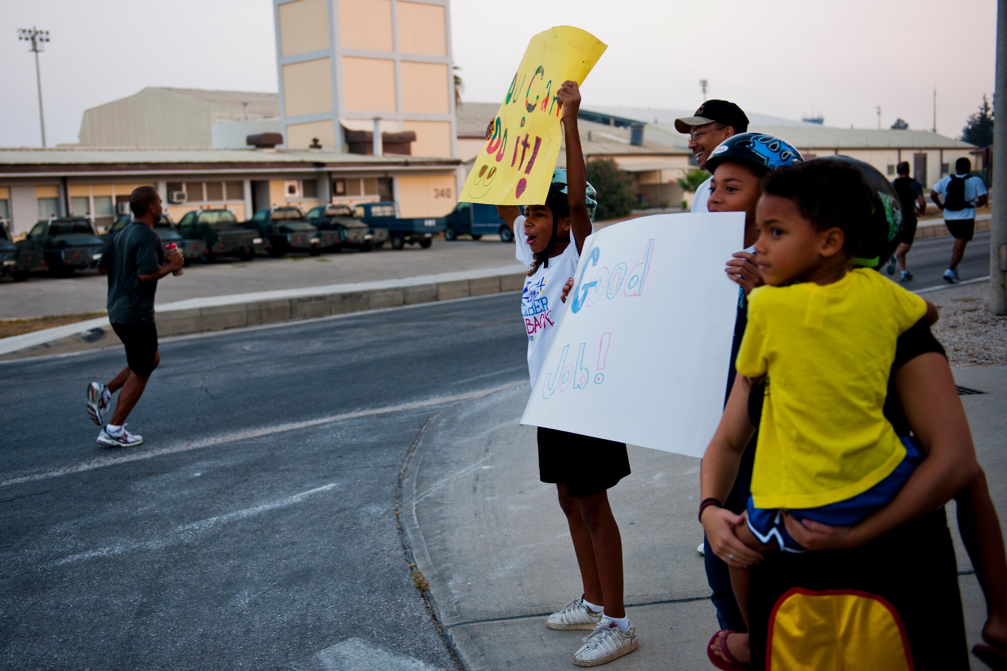 Friends and family cheer for runners during the half marathon Sept. 17, 2011, at Incirlik Air Base, Turkey. More than 80 runners participated in the 13.1 mile race that coincided with the annual Air Force Marathon. (U.S. Air Force photo by Tech. Sgt. Michael B. Keller/Released)
