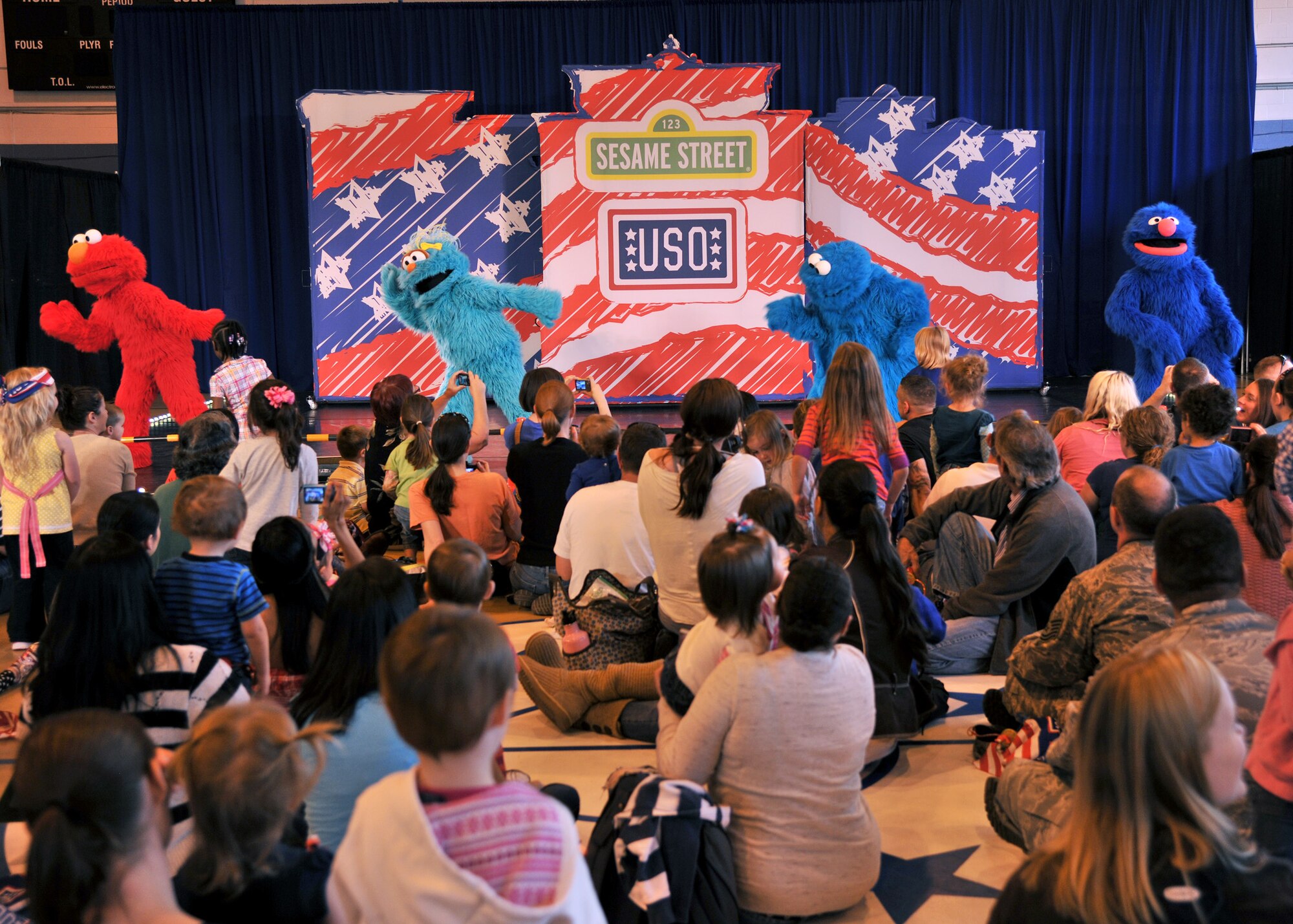 RAF MILDENHALL, England – (From left to right) Sesame Street characters Elmo, Rosita, Cookie Monster and Grover dance the Elmo shuffle during a performance at the Northside Fitness Center here Sept. 15, 2011. The Sesame Street/USO Experience for Military Families tour has toured both stateside and abroad. The 2011 tour focused on the impact a military lifestyle has on children. (U.S. Air Force photo by Senior Airman Jerilyn Quintanilla)