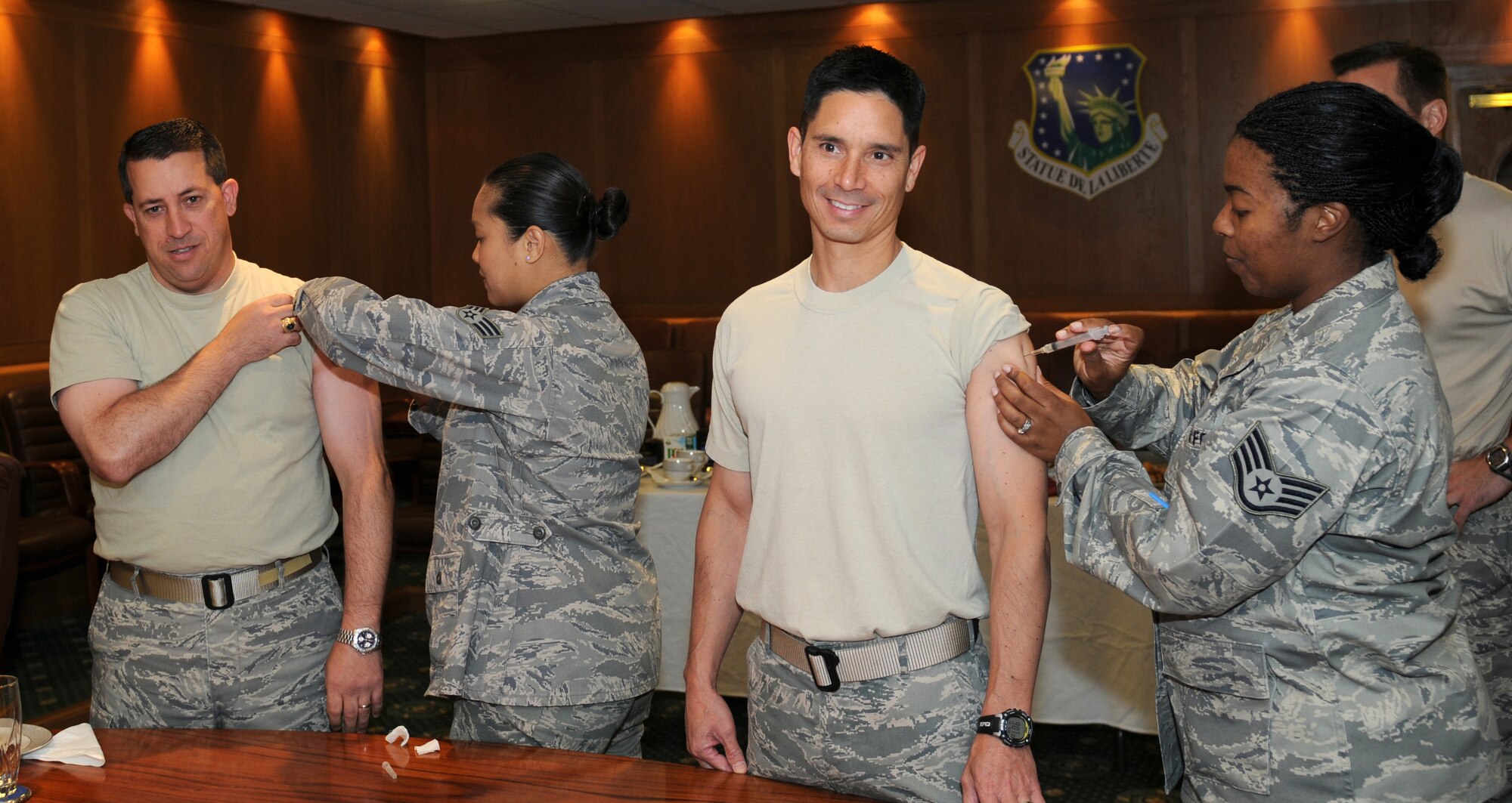 ROYAL AIR FORCE LAKENHEATH, England - Cols. Brian T. Kelly (left), 501st Combat Support Wing commander, and John T. Quintas, 48th Fighter Wing commander, receive flu shots Sept. 9, 2011. It is a requirement for all active duty personnel to receive immunizations during this flu season. (U.S. Air Force photo by Airman Cory Payne)