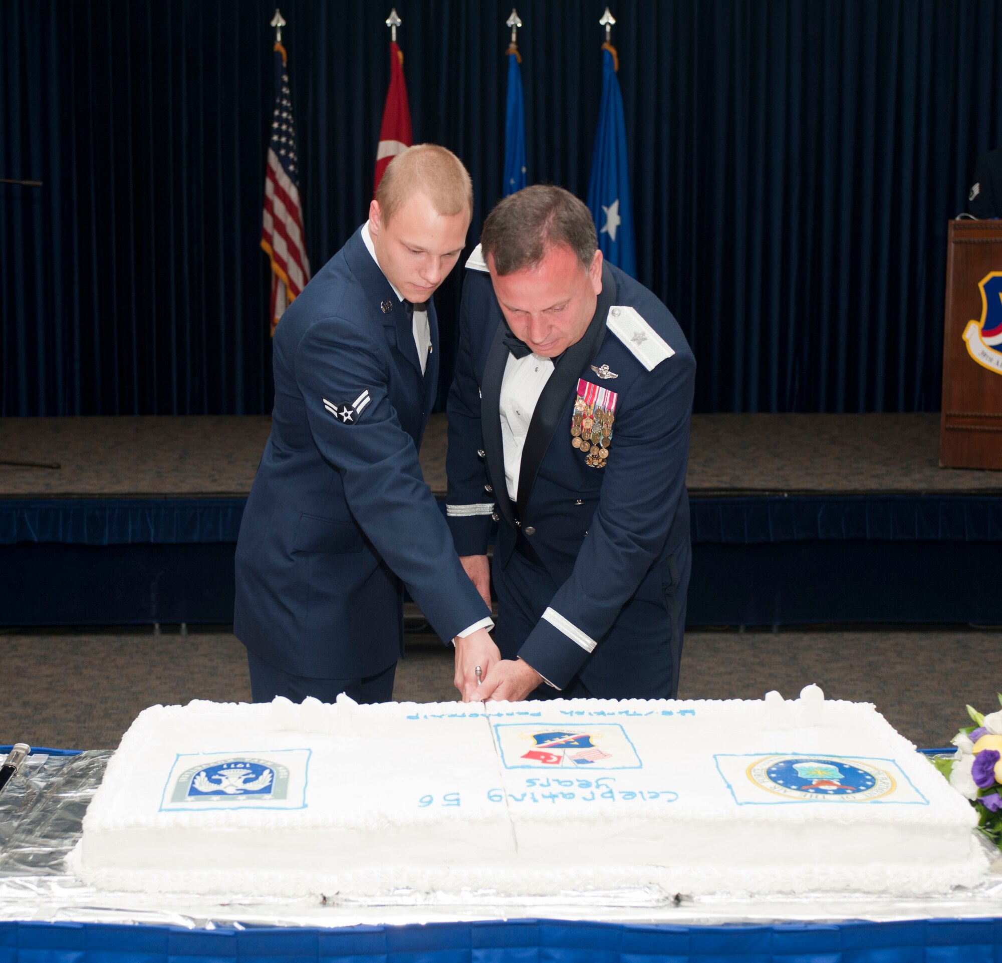 Airman 1st Class Ethan Plautz, 39th Logistics Readiness Squadron, and Brig. Gen. James Daniel, Senior Defense Official and Defense Attache, Office of Defensive Cooperation, Ankara, Turkey, U.S. European Command, make the first cut in the cake as the most junior and senior Airmen, respectively, in attendance at the Air Force Gala Sept. 17, 2011, at the Club Complex at Incirlik Air Base, Turkey. Members from the 39th Air Base Wing and the 10th Tanker Base Command joined together to celebrate the 64th anniversary of the U.S. Air Force and the 100th anniversary of the Turkish air force.(U.S. Air Force photo by Senior Airman Clayton Lenhardt/Released)