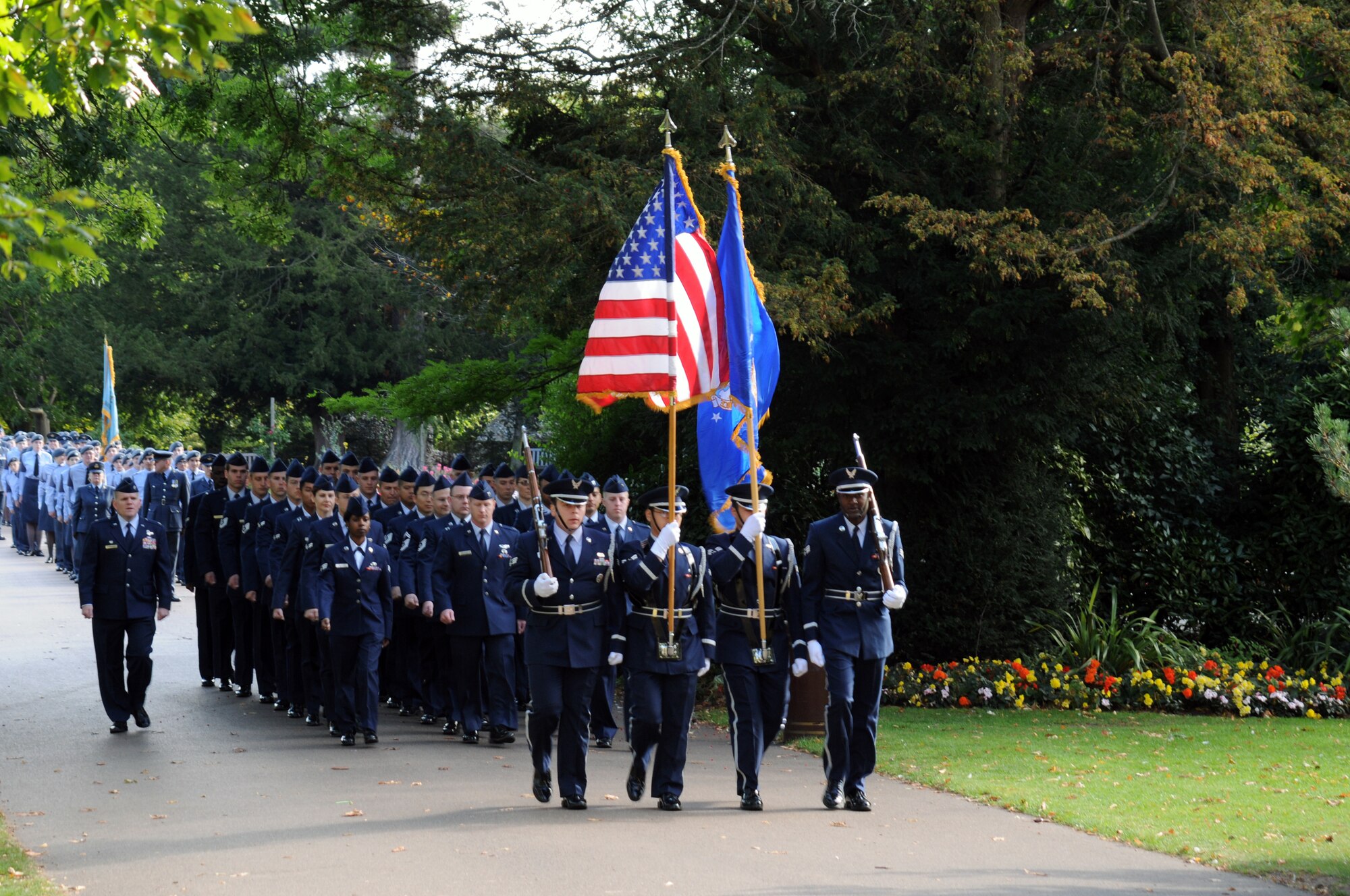 RAF MILDENHALL, England – A formation of Service members and a four-man honor guard team march in the Battle of Britain Parade in Bury St. Edmunds, Suffolk, Sept. 18, 2011. The Airmen from RAF Mildenhall joined RAF Regiment Service members from RAF Honington, RAF Cadets, and World War II veterans, who marched with the Royal British Legion. (U.S. Air Force photo/Tech. Sgt. Kevin Wallace)