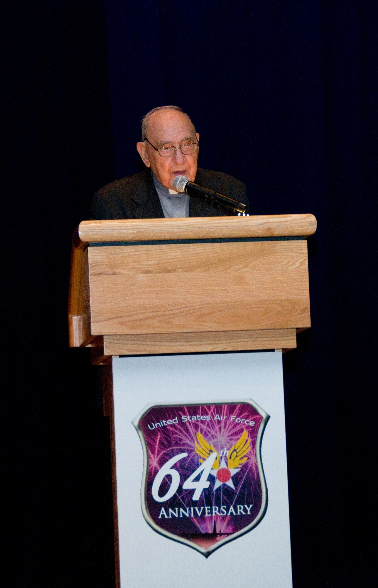 YOKOTA AIR BASE, Japan -- Father Francis Mathy, a retired professor and Roman Catholic priest, gives the invocation at the 64th Anniversary Air Force Ball at Yokota Air Base, Japan, Sept. 17, 2011. Father Mathy has a unique history with Yokota, having served as an Army officer here in 1946. After leaving the service, he became ordained and has since spent more than five decades working in Japan. (U.S. Air Force photo/Airman 1st Class Krystal M. Garrett) 