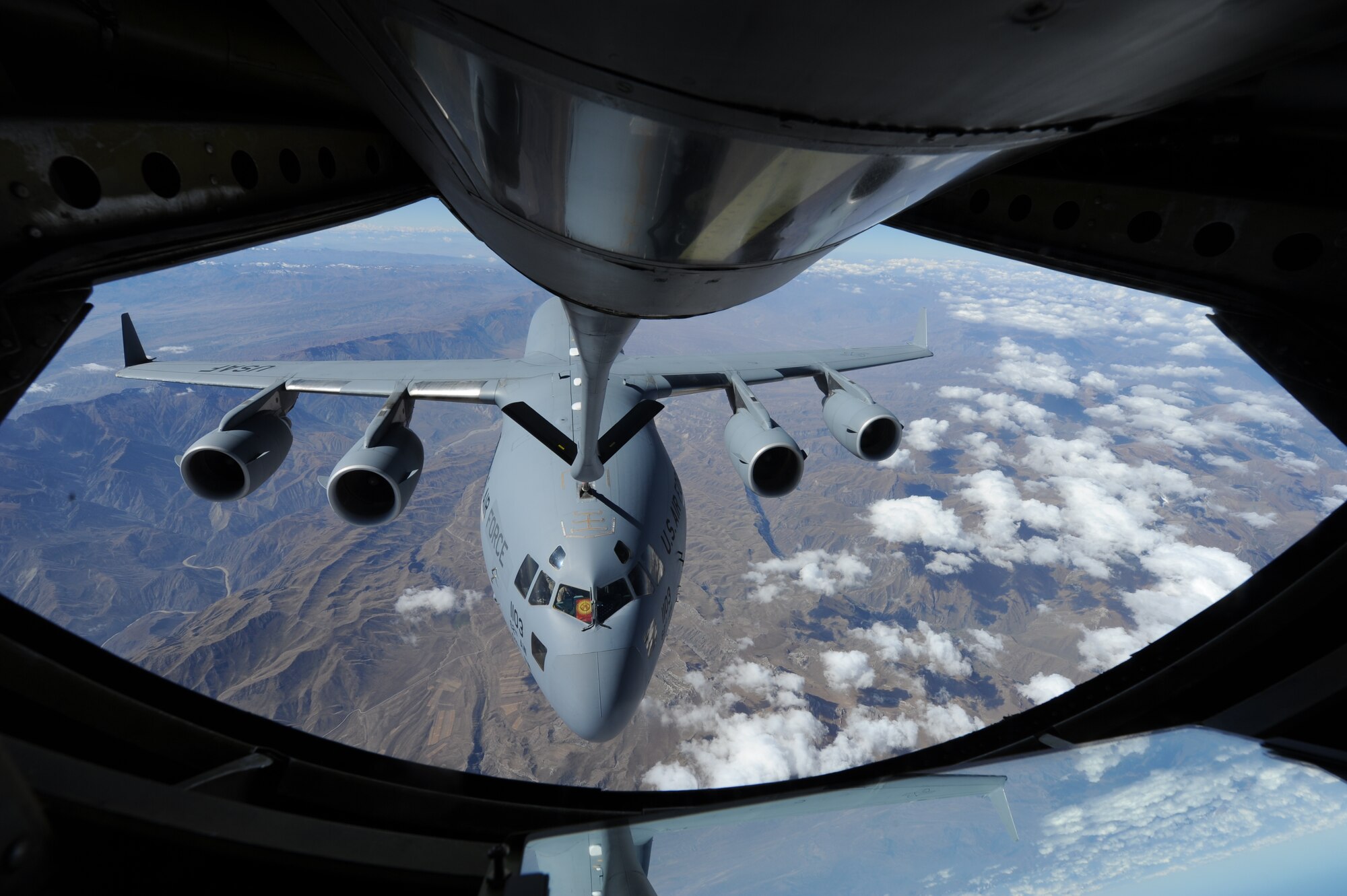 A KC-135 Stratotanker refuels a C-17 Globemaster III during a familiarization flight for members of the Kyrgyz government over Kyrgyzstan Sept. 17. The Transit Center at Manas hosted nine guests from the Jogorku Kenesh, the Kyrgyz Republic's parliament. Five are members of parliament and four are staff members on special committees. This high-level visit underpins Air Forces Central Command and U.S. Central Command goals for sustained partnership building and cultivating enduring relationships in support of U.S. foreign policy objectives. (U.S. Air Force photo/Tech. Sgt. Hank Hoegen)