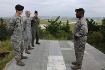 KUNSAN AIR BASE, Republic of Korea -- Brig. Gen. Jimmy McMillian, Director of Security Forces, Deputy Chief of Staff for Logistics, Installations and Mission Support, Headquarters U.S. Air Force, Washington, D.C., receives a briefing from Airmen of the Wolf Pack here Sept. 13. Three Airmen from different squadrons were selected to brief McMillian on the three Wolf Pack mission statements. (U.S. Air Force photo/Senior Airman Brittany Y. Bateman) 