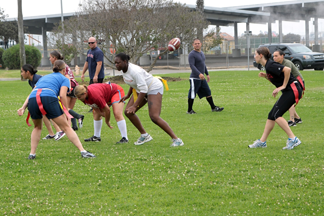 The Headquarters and Service Battalion powder puff football team scrimmages during practice Monday to get a feel for the pace of a real game. The team will compete in a two-day tournament here Oct. 18-19. The winning team will then proceed to compete in a tournament against the Marine Corps Air Station Miramar and Marine Corps Base Camp Pendleton victors aboard MCAS Miramar for the tri-base championship title Oct. 20.