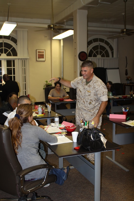 Lt. Stephen Brown, 2nd Recruit Training Battalion chaplain, helps couples with their workbook entries during a Prevention and Relationship Enhancement Program aboard Marine Corps Recruit Depot San Diego Sept. 19.The class helped couples learn how to better communicate and identify risk factors in a marriage.