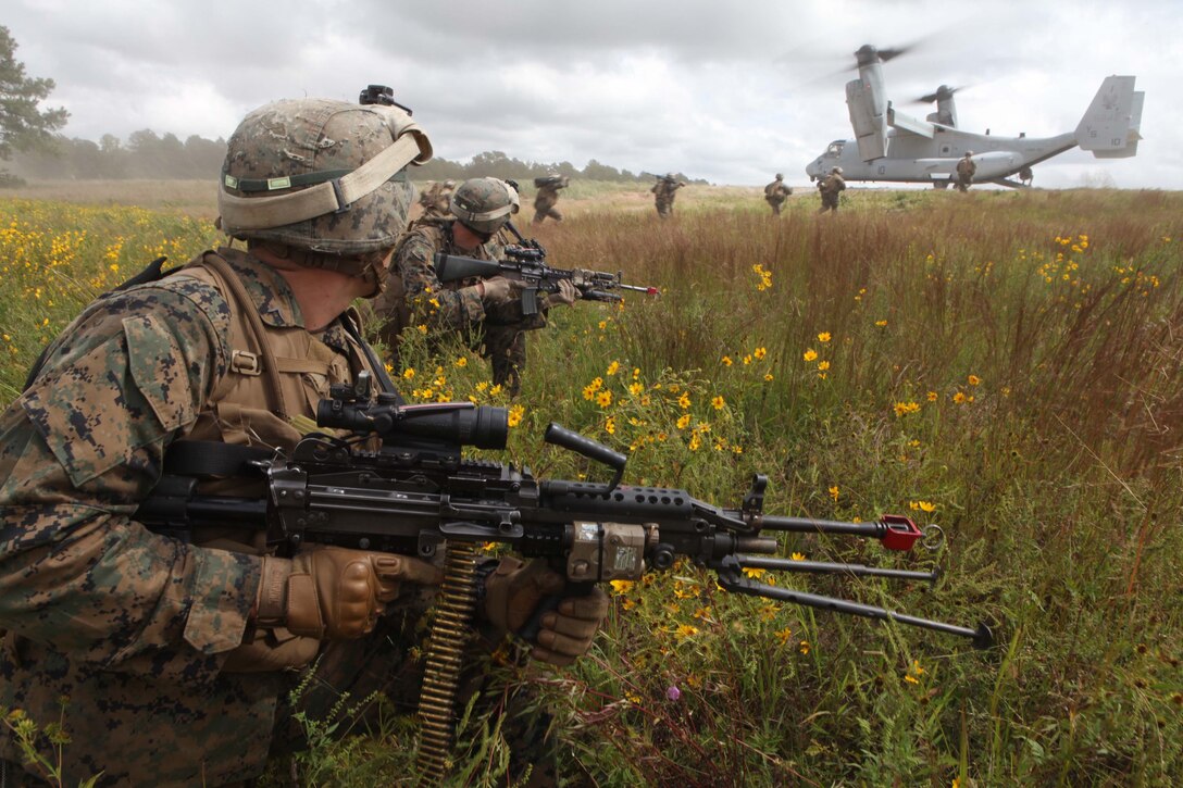Marines from Bravo Company, 1st Battalion, 2nd Marine Regiment, post security while rushing onto a MV-22 Osprey after conducting a simulated raid on Fort Pickett's Cherry Villiage, Va., Sep. 19, 2011. More than 900 Marines and Sailors are taking part in the Deployment for Training exercise at Fort Pickett, Sept. 6-23. The battalion is scheduled to attach to the 24th Marine Expeditionary Unit as its Battalion Landing Team a few days after the training.