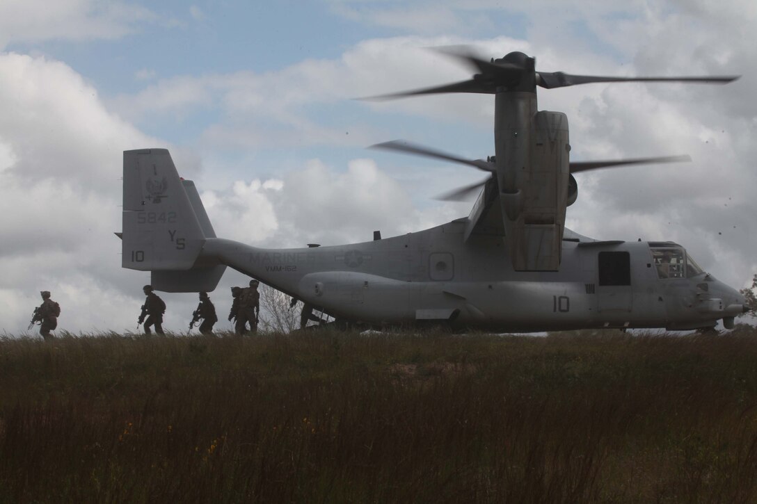 Marines from Bravo Company, 1st Battalion, 2nd Marine Regiment, exit an MV-22 Osprey before conducting a simulated raid on Fort Pickett's Cherry Villiage, Va., Sep. 19, 2011. More than 900 Marines and Sailors are taking part in the Deployment for Training exercise at Fort Pickett, Sept. 6-23. The battalion is scheduled to attach to the 24th Marine Expeditionary Unit as its Battalion Landing Team a few days after the training.