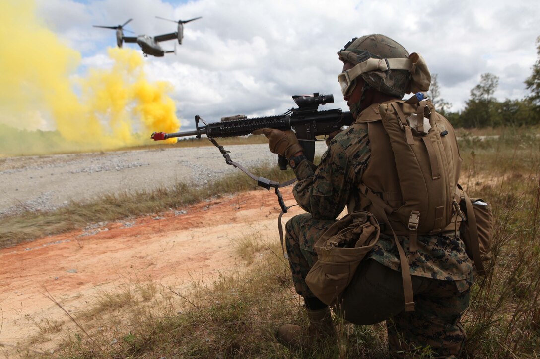 Private First Class Cassius Johnson, a rifleman with Bravo Company, 1st Battalion, 2nd Marine Regiment, and Summit, Miss., native, posts security as an MV-22 Osprey lands near Fort Pickett's Cherry Villiage, Va., Sep. 19, 2011. More than 900 Marines and Sailors are taking part in the Deployment for Training exercise at Fort Pickett, Sept. 6-23. The battalion is scheduled to attach to the 24th Marine Expeditionary Unit as its Battalion Landing Team a few days after the training.