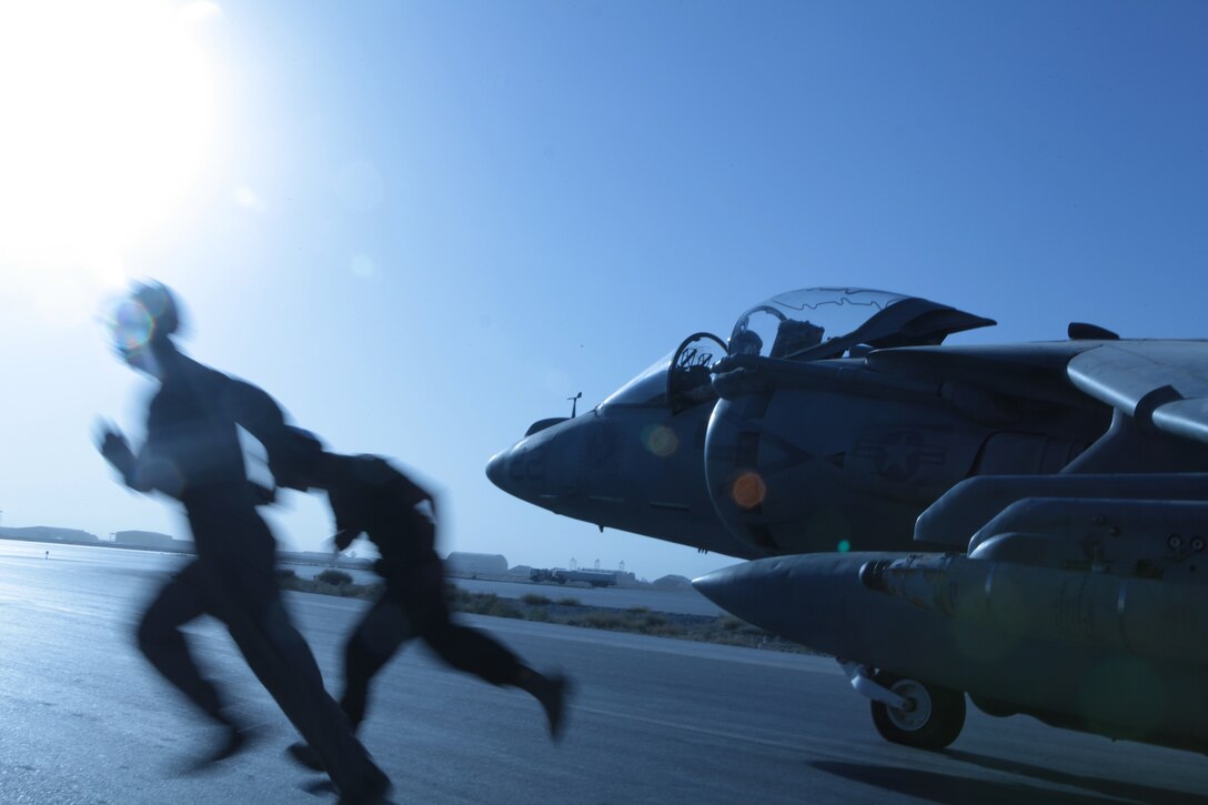 Marine Attack Squadron 513 ordnance technicians Cpl. Timothy Johnson, left, a Huntsville, Texas, native, and Lance Cpl. Devin Davis, a Washington Courthouse, Ohio, native, successfully arm one of the squadron’s AV-8B Harriers on the flightline of Kandahar Airfield, Afghanistan, Sept. 20.