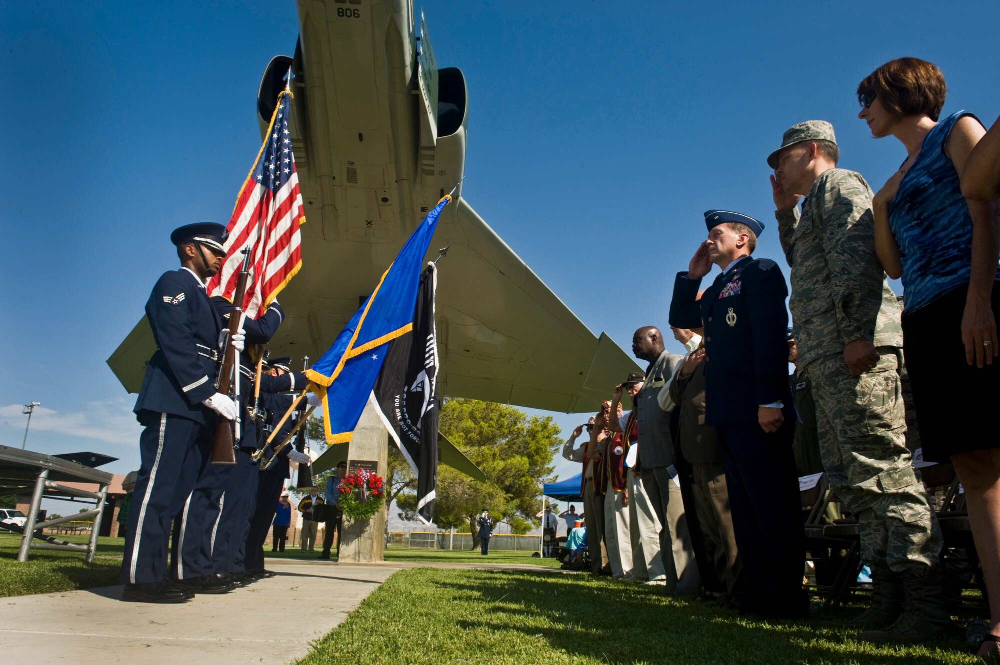 U.S. Air Force Nellis Honor Guard post the Colors during the National Anthem at the National Prisoners of War/Missing in Action Recognition Day ceremony Sept. 16, 2011, at Freedom Park on Nellis Air Force Base, Nev. The ceremony included the dedication of a POW/MIA ceremonial wreath, the reciting of names of Nevadans who are war prisoners and those who are still missing, a 21-gun salute by a rifle firing party and an F-16 Fighting Falcon flyover. (U.S. Air Force photo by Senior Airman Brett Clashman/Released)
