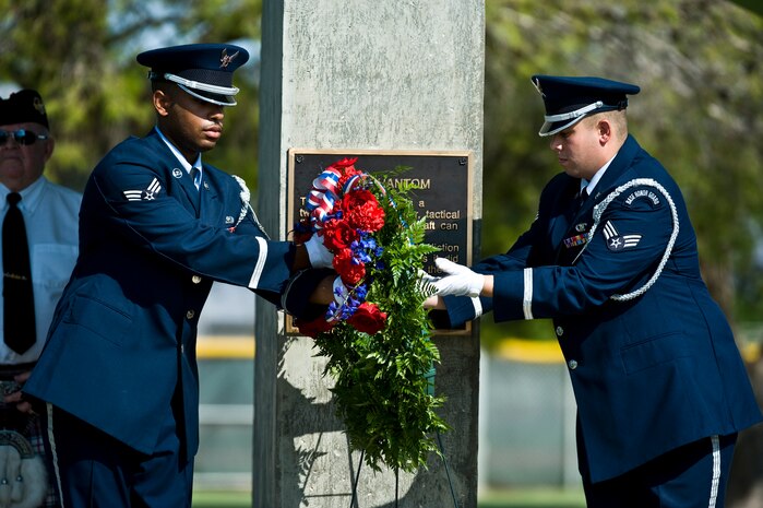 U.S. Air Force Nellis Honor Guard members move the memorial wreath at the National Prisoners of War/Missing in Action Recognition Day ceremony Sept. 16, 2011, at Freedom Park on Nellis Air Force Base, Nev. The ceremony included the dedication of a POW/MIA ceremonial wreath, the reciting of names of Nevadans who are war prisoners and those who are still missing, a 21-gun salute by a rifle firing party and an F-16 Fighting Falcon flyover. (U.S. Air Force photo by Senior Airman Brett Clashman/Released)