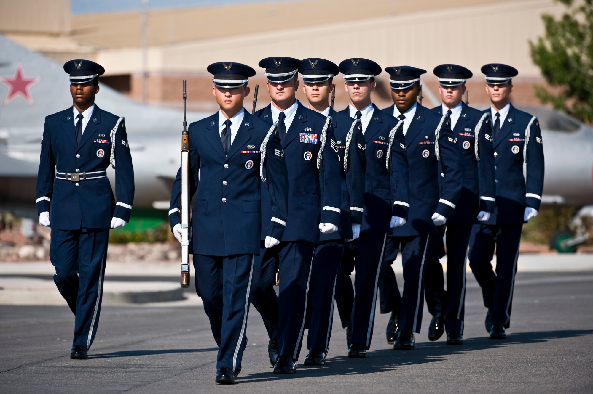 U.S. Air Force Nellis Honor Guard firing party marches in formation before the National Prisoner of War/Missing in Action Recognition Day ceremony Sept. 16, 2011, at Freedom Park on Nellis Air Force Base, Nev. The ceremony included the dedication of a POW/MIA ceremonial wreath, the reciting of names of Nevadans who are war prisoners and those who are still missing, a 21-gun salute by a rifle firing party and an F-16 Fighting Falcon flyover. (U.S. Air Force photo by Senior Airman Brett Clashman/Released)
